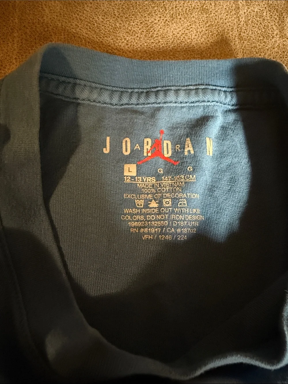 Jordan Blue Short-Sleeve Tee with Distressed Multi-Color Logo
